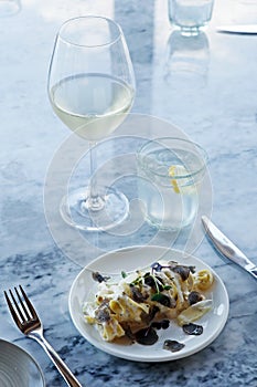 italian food pasta dish with pairing wine on a dining table for food photography