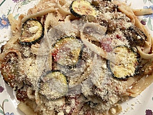 Italian Food Pasta With Eggplant, Zucchin, Sun Dried Tomatoes and Parmesan Cheese