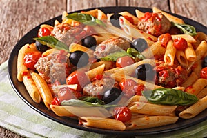 Italian Food: Pasta with meatballs, olives and tomato sauce closeup. horizontal