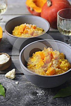 Italian food. Plate of pumpkin risotto and grated parmesan cheese