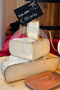 Italian food products, seasoned Goat cheese priced with pure goat written tag