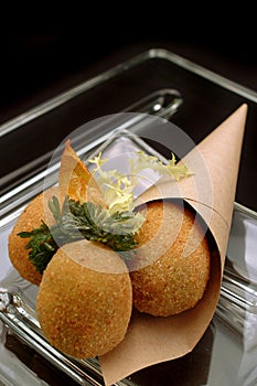 Italian Food Recipe Olive all`ascolana  in cornet  in to a glass dish.  Typical  Italian street-food appetizer.