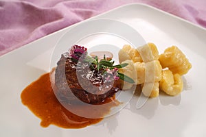 Italian food recipes, veal cheek in Barbera red wine with potato dumplings photo