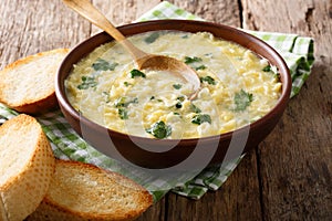 Italian food: soup stracciatella with farfalline and cheese close-up. horizontal