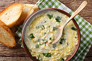 Italian food: soup stracciatella with farfalline and cheese close-up. horizontal top view