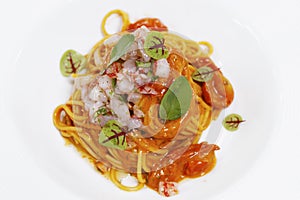 Italian food speciality, spaghetti or linguni pasta seafood sauce with red prawns( gambero rosso) tartare photo