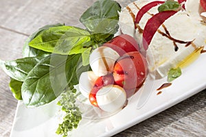 Italian food tomatos mozzarella and basil with olive oil and balsamic vinegar