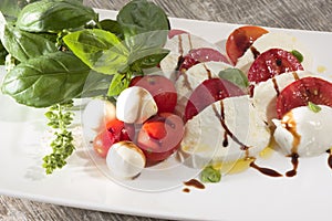 Italian food tomatos mozzarella and basil with olive oil and balsamic vinegar