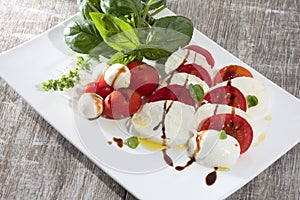 Italian food tomatos mozzarella and basil with olive oil and balsamic vinegar