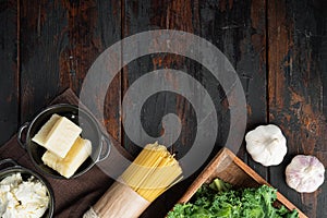 Italian food. Vegetables, olive oil, herbs and pasta, on old dark  wooden table background, top view flat lay , with copyspace