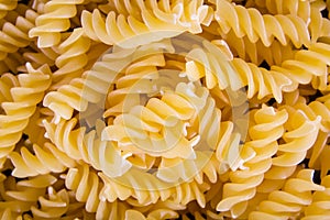 Italian Fusilli, Rotini or Scroodle Macaroni Pasta food background texture