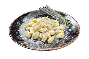 Italian gnocchi dumplings, Raw potato gnocchi on plate with thyme. Isolated on white background. Top view.