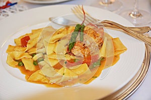 Italian gourmet food pasta with lobster dish on table