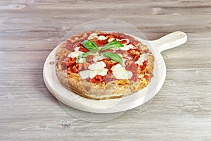 Italian gourmet pizza on wooden chopping board