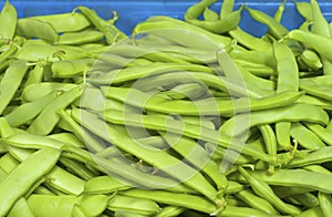 Italian Green Romano Beans in bin on display for sale in Farmers Market. Grown in Portland, Oregon, USA