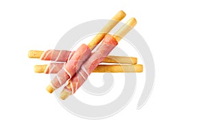 Italian grissini breadsticks with Parma ham prosciutto isolated on white background top view
