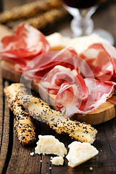 Italian ham with breadsticks photo