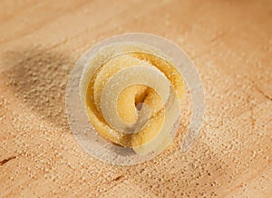 Italian homemade tortellino placed on wooden table,sprinkled with flour. photo