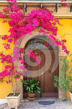 Italian house exterior with bougainvillea flowers on the wall in town Positano, Amalfi coast, Campania, Italy