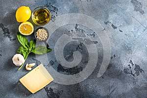 Italian ingredients for pesto genovese sauce background, healthy food concept on a vintage stone grey background Basil, olive oil