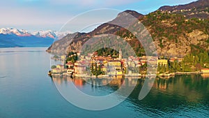 Italian Lake Como and Varenna town landscape at sunset, Alps snowy mountain background