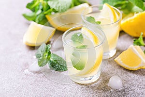 Italian lemon lime liqueur limoncello with ice and mint