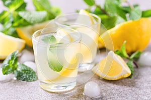 Italian lemon lime liqueur limoncello with ice and mint