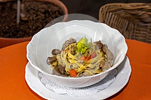 Italian linguini pasta with chicken hearts and herbs