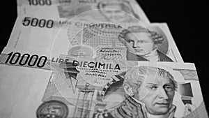 Italian Lire banknotes on a black background. it was the ex Italian currency