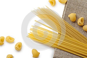 Italian macaroni shells and spaghetti with rope on brown bagging