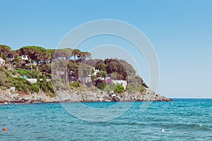 Italian maritime coast of the Island of Elba with rocky ridge and perched house. Sea in Italy in the city of Procchio