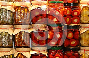 Italian market with pots of peppers and anchovies in olive oil