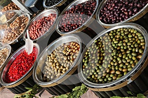 Italian market stall with olives and red peppers for sale