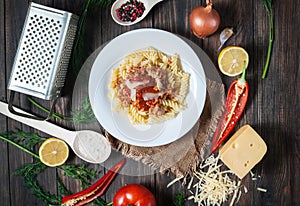 Italian meat sauce pasta and fresh delicious ingredients for cooking on rustic background