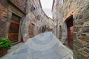 Italian medieval village details, historical stone alley, ancient marrow street, old city stone buildings architecture. Radicofani