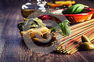 Italian and Mediterranean food ingredients on old wooden background.