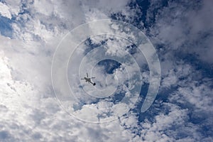 Italian Military Helicopter against a Blue Sky with Clouds - Italy