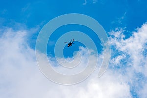 Italian Military Helicopter against a Clear Blue Sky with Clouds - Italy