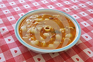 Italian minestrone dish typical of healthy cuisine with vegetables, beans, potatoes, peas, pasta