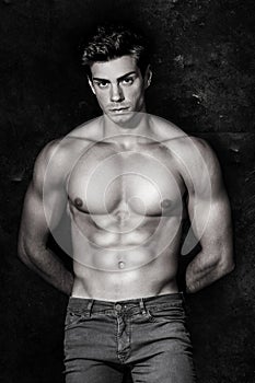 Italian model muscular man. Nude portrait. Black and white photo