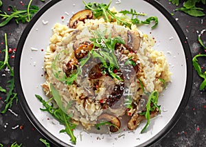 Italian Mushroom risotto with parmesan cheese and wild rocket on top.