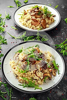 Italian Mushroom risotto with parmesan cheese and wild rocket on top.