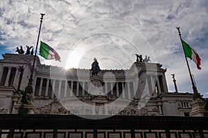 Italian national flag with scenic view on the front facade of Victor Emmanuel II monument on Piazza Venezia in Rome. Sunrise