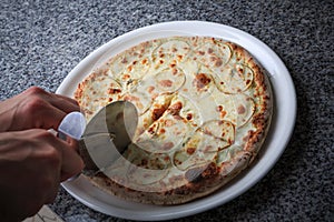 pizza with pear and gargantilla on a white plate photo