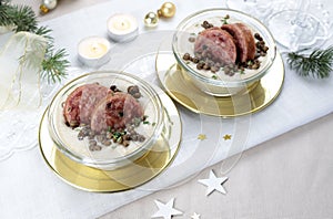 An Italian New Year Eve table. Slices of cotechino with lentil cream.