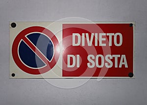 italian no parking (divieto di sosta) sign with car light reflec photo
