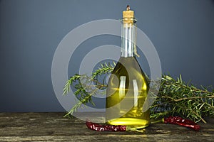 Italian olive oil in bottles with aromatic herbs
