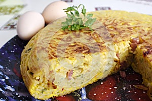 Italian omelet of pasta made with spaghetti and speck