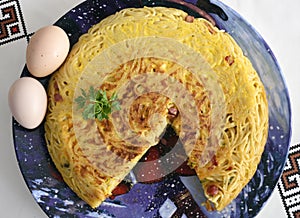 Italian omelet of pasta made with spaghetti and speck