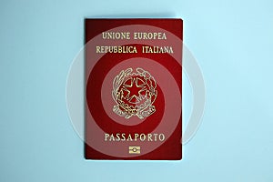 Italian passport on blue background close up